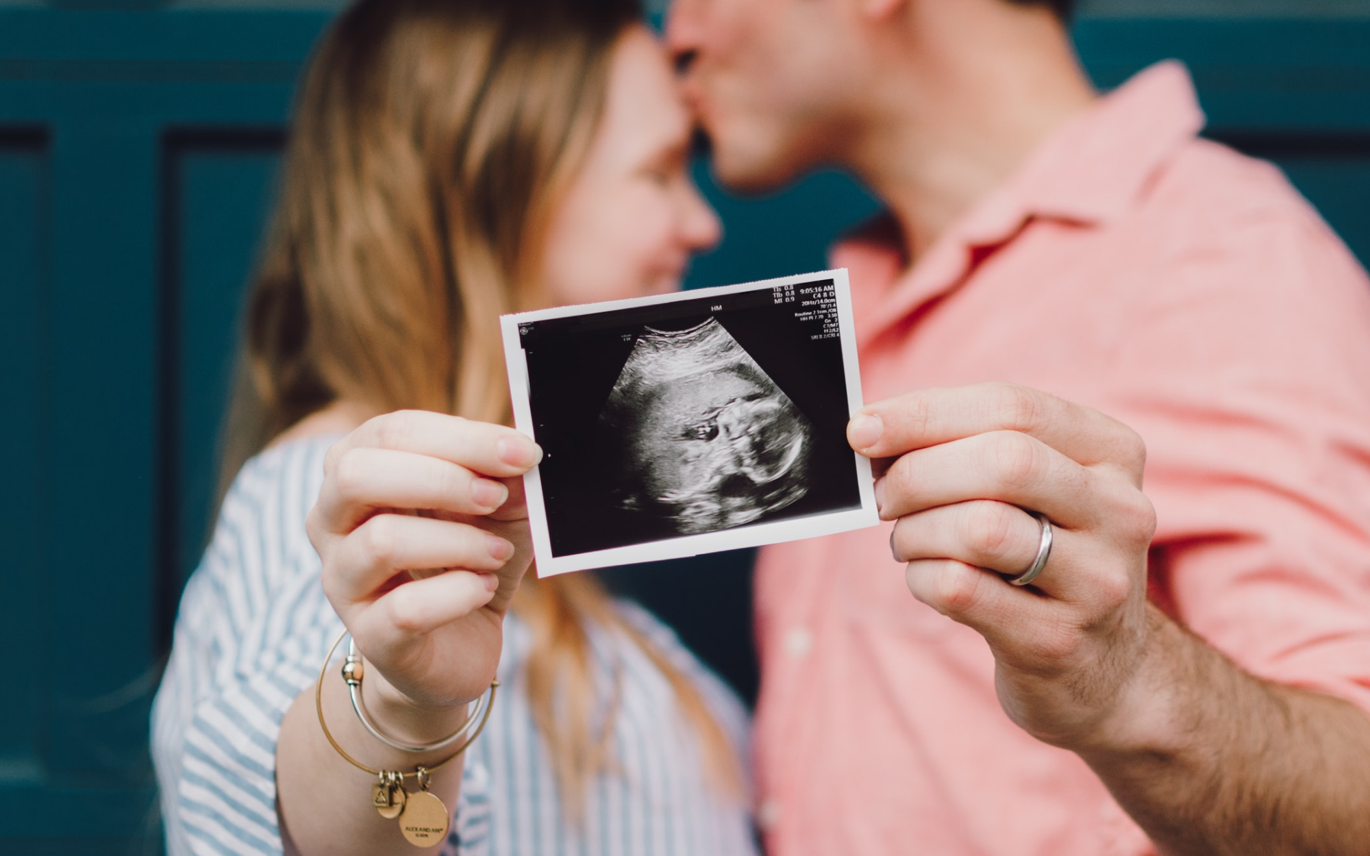 Parents holding first baby picture