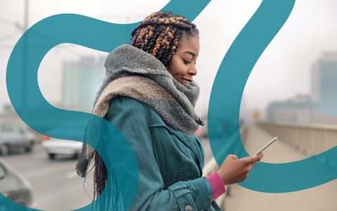 A woman using the Anemocheck app bundled in winter coats outside