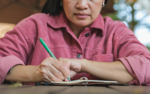 Anemic woman writing down her new years resolution